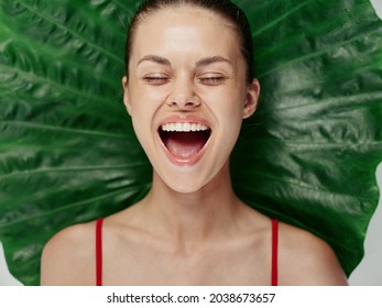 Woman With Closed Eyes With Mouth Wide Open Fun Close Up Palm Leaf