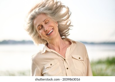 Woman With Closed Eyes And Wind In Her Hair