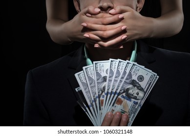 Woman Closes Mouth A Man In Suit Holds Money. Bribe And Corruption. Free Speach
