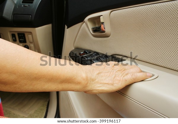 Woman is closing the\
car door in a car.