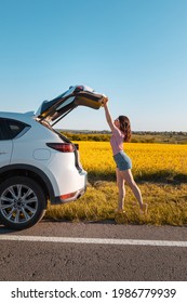 Woman Closing Car Trunk Parked At Roadside Copy Space