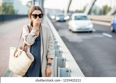 Woman Closing Her Nose Feeling Bad Because Of The Air Pollution On The Bridge With Traffic In The City