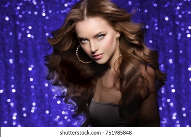 Woman club lights party background Dancing girl Long hair. Waves Curls Updo Hairstyle. Fashion model in salon with shiny healthy luxurious haircut.  Jewelry Bracelets Earrings