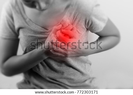 Woman is clutching her chest, acute pain possible heart attack.  black and white photo