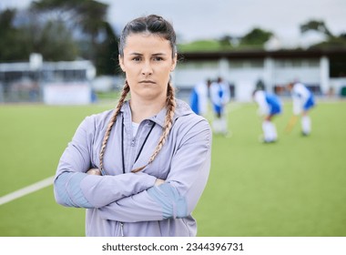 Woman coach, arms crossed and field for sports, hockey and portrait for teaching, fitness and exercise. Girl, serious face and guide for development, leadership and training for competition on grass - Powered by Shutterstock