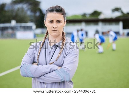 Woman coach, arms crossed and field for sports, hockey and portrait for teaching, fitness and exercise. Girl, serious face and guide for development, leadership and training for competition on grass