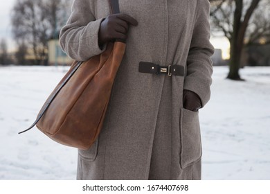 Woman In Coat With A Large Leather Bag On His Shoulder