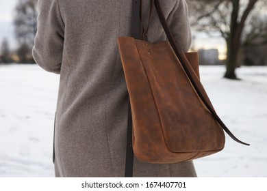 Woman In Coat With A Large Leather Bag On His Shoulder