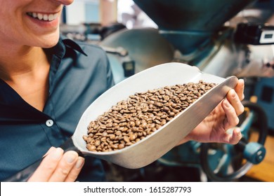 Woman in coffee roastery with fresh beans full of aroma - Shutterstock ID 1615287793