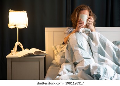 Woman With Coffee Or Tea Cup In Bed Night Time Rest