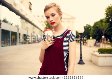  woman with coffee walking around the city                              