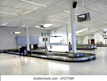 Woman Collect Bag From Luggage Carousel At Adelaide Airport