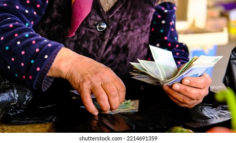 Woman Collecting Money From Buyer Bazar