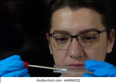 A Woman Collects Forensic DNA Sample Stick