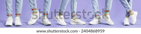 Woman in colorful socks, white sneakers and jeans on violet background, closeup. Collection of photos