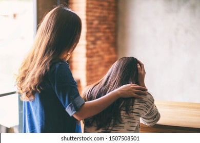 A Woman Comforting And Giving Encouragement To Her Sad Friend