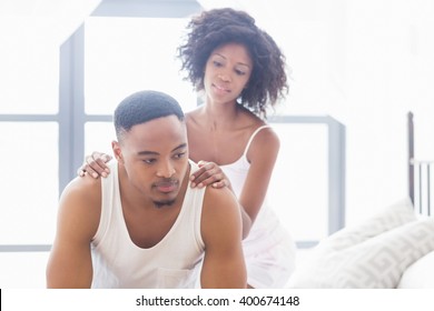 Woman comforting her man in bedroom at home