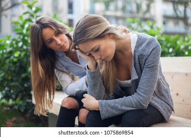 Woman Comforting To A Sad Depressed Friend Who Needs Help. Depression Concept