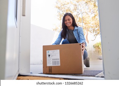 Woman Coming Back To Home Delivery In Cardboard Box Outside Front Door