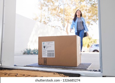 Woman Coming Back To Home Delivery In Cardboard Box Outside Front Door