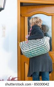 Woman Coming Home With Her Groceries And Standing At The Front Door