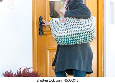 Woman Coming Home With Her Groceries And Standing At The Front Door