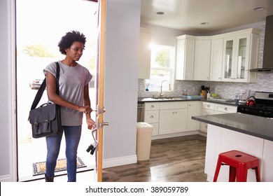 Woman Coming Home From Work And Opening Door Of Apartment