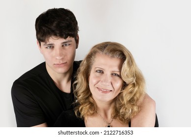 A Woman Communicates And Smiles With Her Teenage Son, A Mother Is Proud That She Has Grown A Smart, Beautiful Son. A Teenage Boy Tenderly Hugs His Mother, Together They Solve Teenage Problems