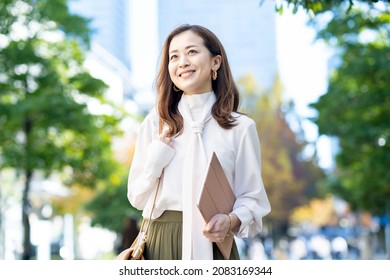 woman commuting in office casual style - Shutterstock ID 2083169344