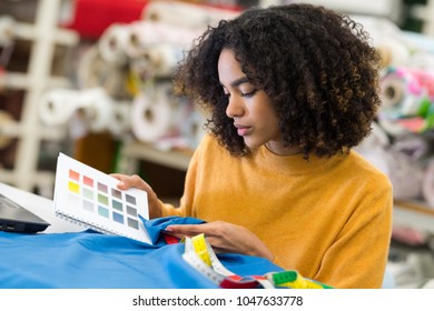 Woman Comparing Fabric Color To Color Preferred By Her Client