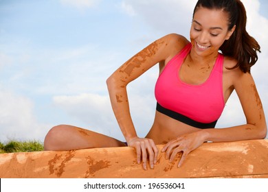 Woman Competing In A Mud Run Race
