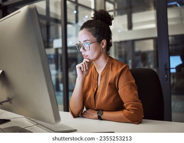 Woman, computer and office with glasses show reflection on face while working overtime. Girl, thinking and idea read analytics, email or communication online at work late at business in the night - Shutterstock ID 2355253213