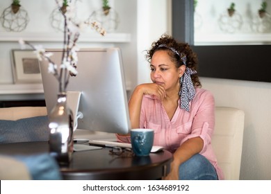 Woman concentrating and working from her home office.