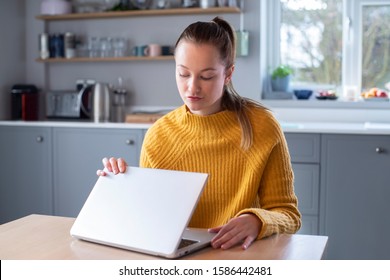 Woman Concerned About Excessive Use Of Internet Closing Lid Of Laptop Computer