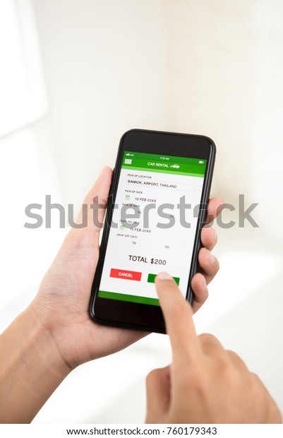 Woman confirming online money payment for
car rental booking reservation on mobile
phone