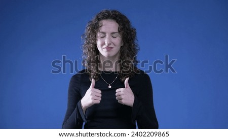 Woman congratulating herself by clapping hands and pointing at herself with sign of self approval for success and victory showing thumbs up