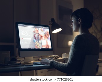 Woman connecting with her computer and shopping online late at night