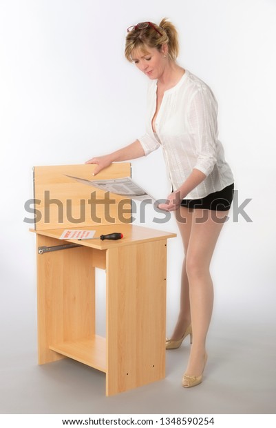 Woman Constructing Personal Computer Desk Flatpack Stock Photo