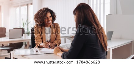 Woman consulting with a female financial manager at the bank