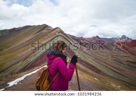 Woman on the top of the Rainbow Mountain, Peru.