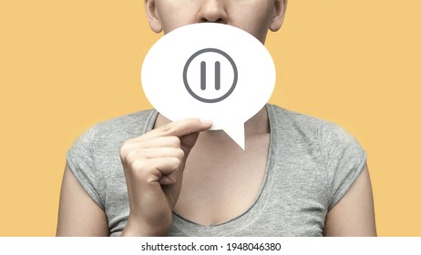 A woman with a conversational cloud in her hand and a pause icon on it. the pause symbol in the conversation
 - Shutterstock ID 1948046380
