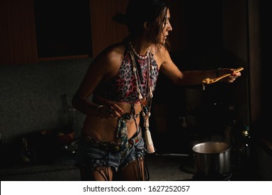 Woman Coocking In The Kitchen Against Window