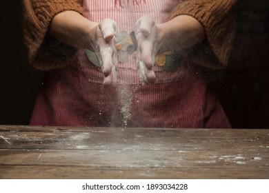 Woman Cook Dusting Off Hands To Clean Them From Flour After Baking,home Cooking In Rustic Vintage Kitchen,on Wooden Table Worktop,traditional Bakery Workshop Making Bread,pasta,pie Or Cake,copy Space