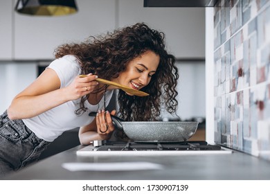 Woman cooker making pasta at the kitchen - Powered by Shutterstock