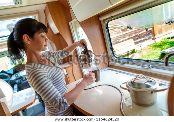 Woman
cooking in camper, motorhome interior VR. Family vacation travel,
holiday trip in motorhome, Caravan car
Vacation.