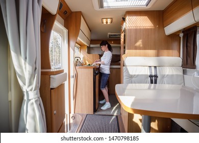 Woman Cooking In Camper, Motorhome RV Interior. Family Vacation Travel, Holiday Trip In Motorhome, Caravan Car Vacation.