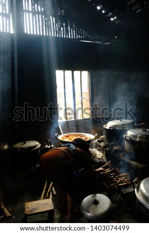 a woman cooking cuisine in an old Javanese kitchen. 