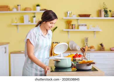 Woman cooking dinner in kitchen - Powered by Shutterstock