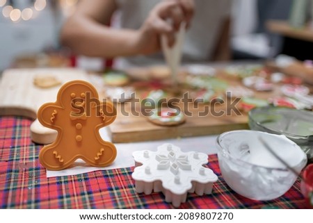 Woman cooking gingerbread on winter holiday at home. Homemade Xmas cookie for Christmas and Happy New Year.