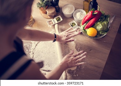 Woman Cooking Healthy Balanced Food.Carbohydrates.Whole Grains.Dieting.Cooking Food At Home.Woman Preparing Dough On Wooden Table In The Kitchen.Rolled Out Dough On Table With Rolling Pin.Pizza Crust